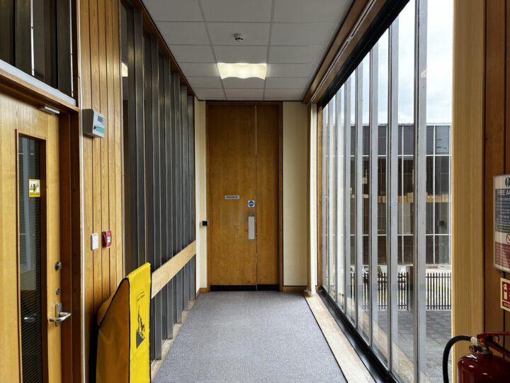 A corridor with a large window.